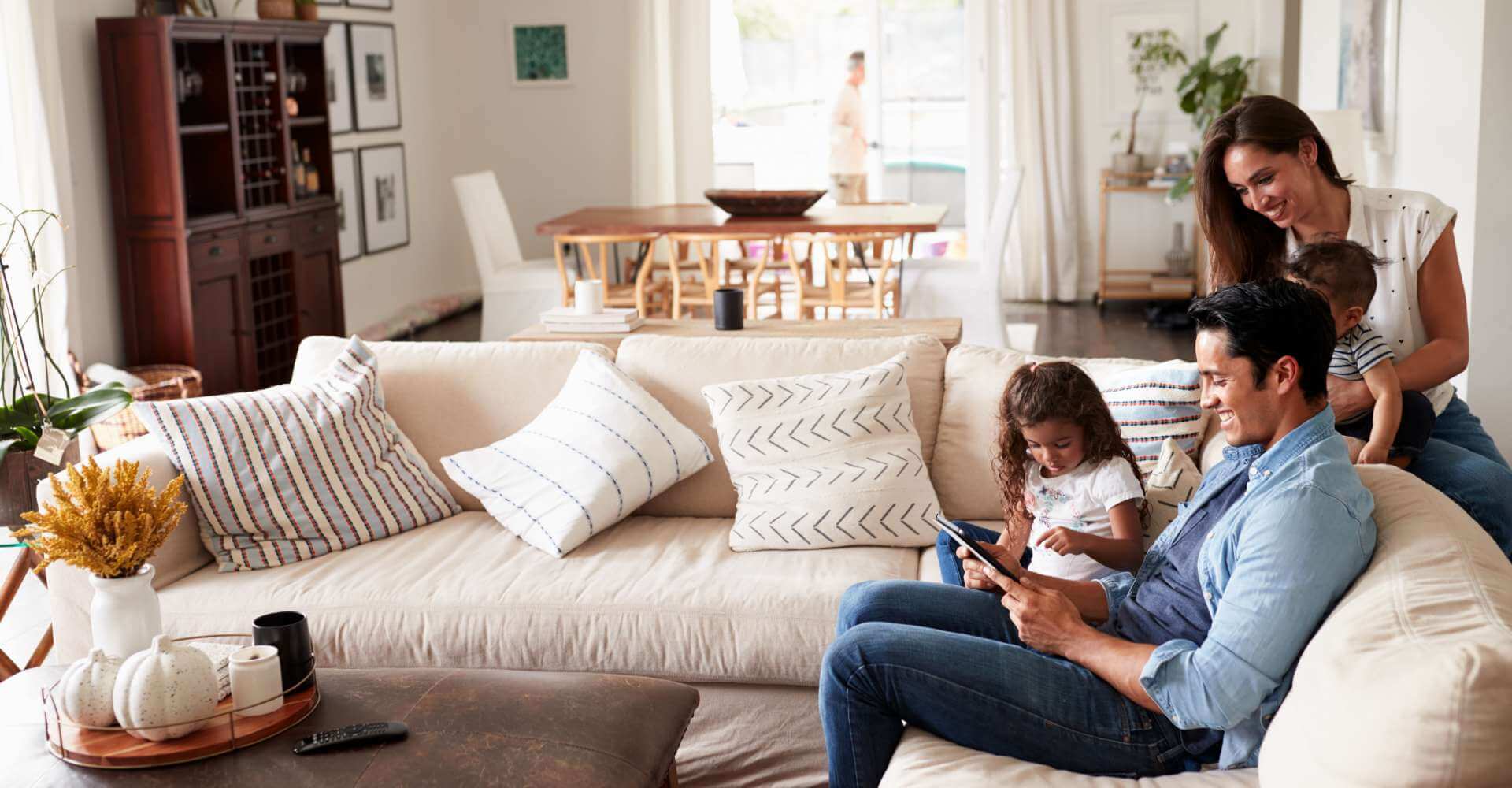 Family playing on tablet in their living room